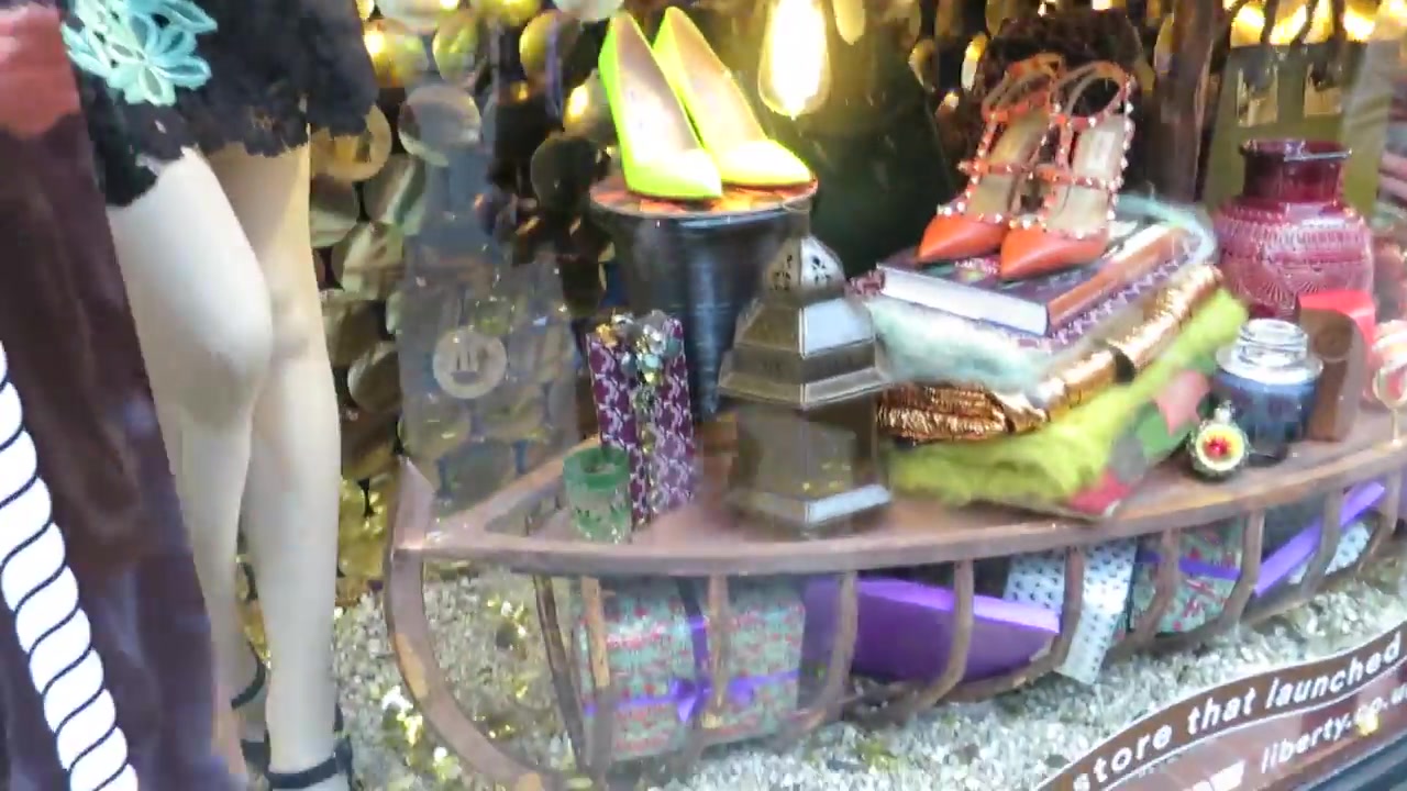 Colourful shoes and accessories in a gold Liberty Christmas window display from 2014