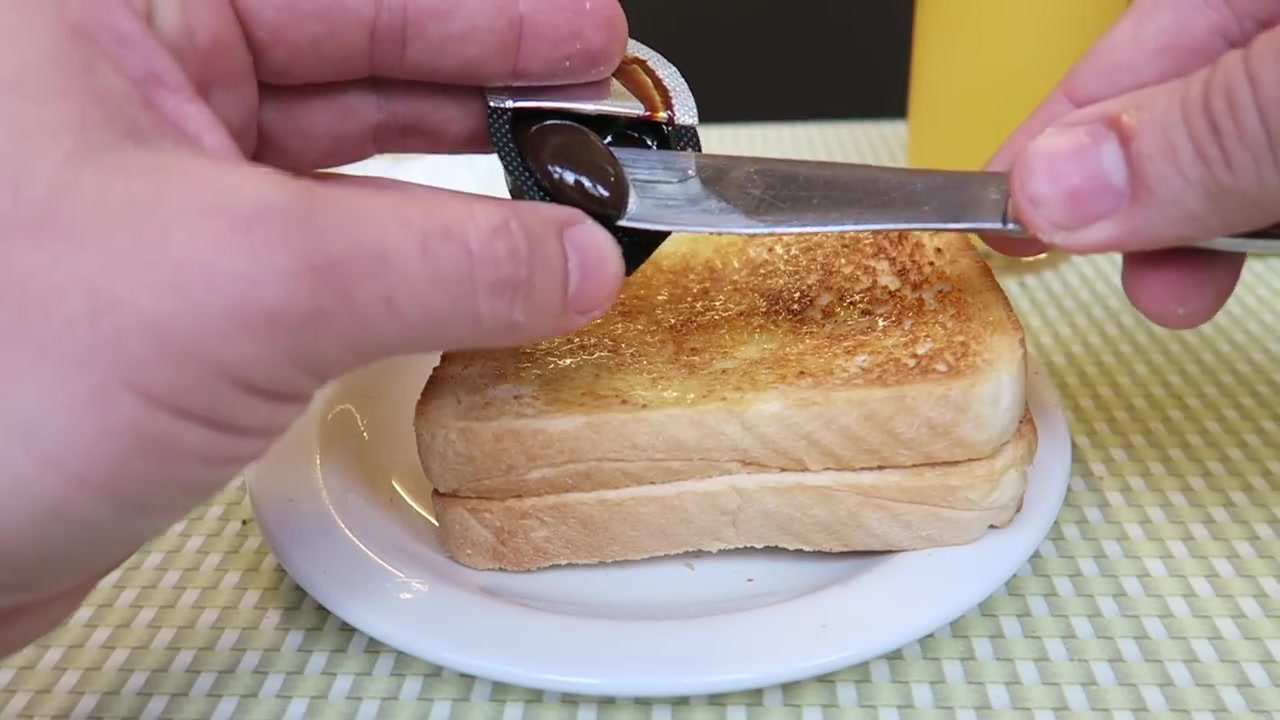 Marmite being spread thinly on toast at the Regency Café.