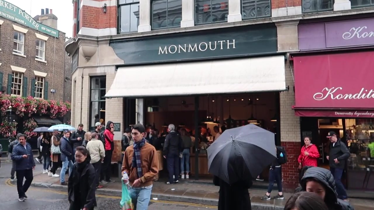 Monmouth Coffee corner shop with customers outside at Borough Market
