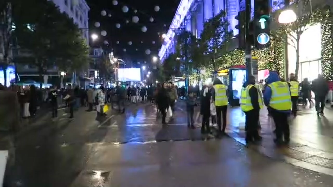 Police and pedestrians beneath the Oxford Street Christmas lights in 2016