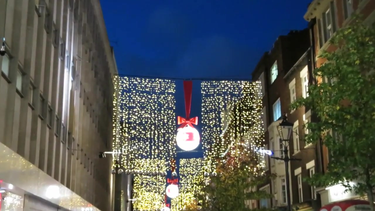 Large illuminated Christmas panel spanning a side street near Oxford Street in 2014.