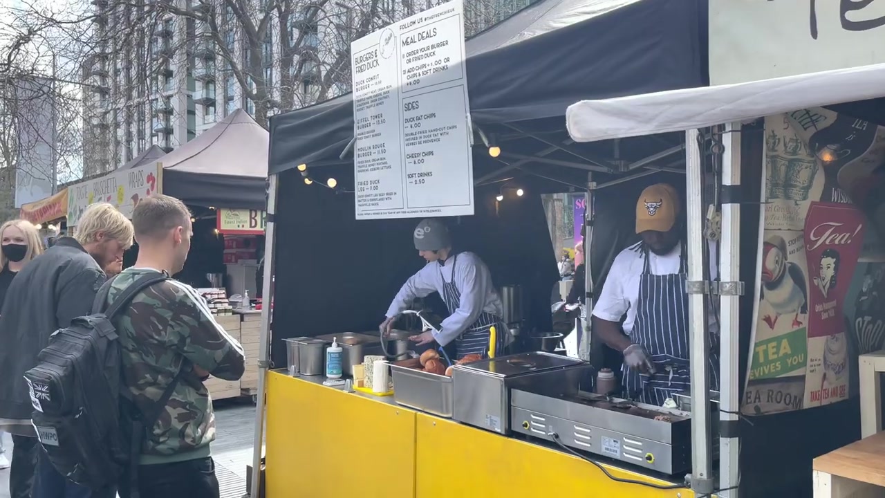 The Frenchie street-food stall with chefs working behind its yellow griddle at Southbank Centre Food Market.