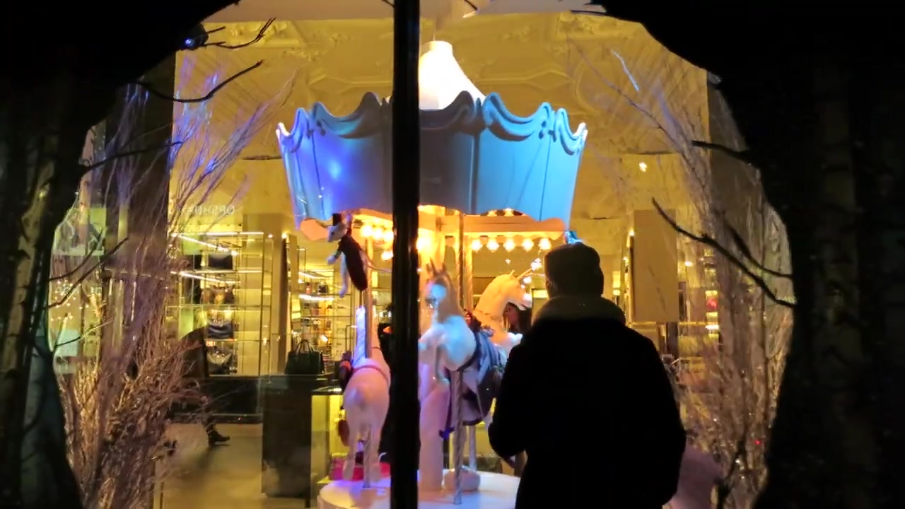 Visitors entering a winter-themed Harrods Christmas display in Knightsbridge