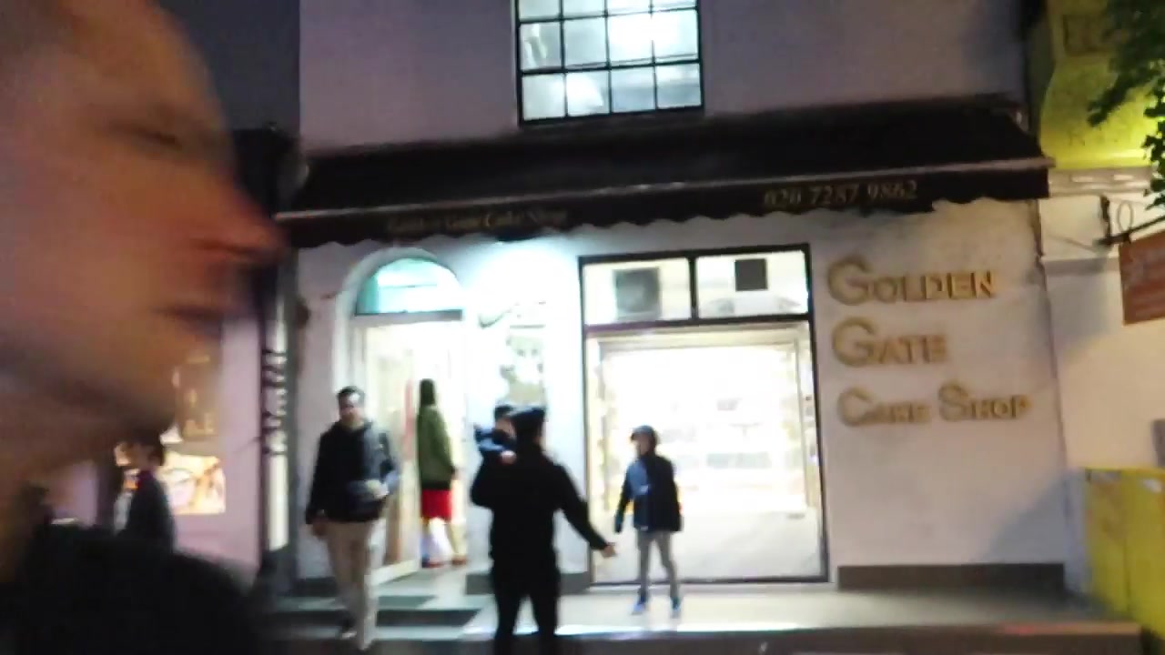 Chinese bakery exterior and illuminated display window in London Chinatown at night
