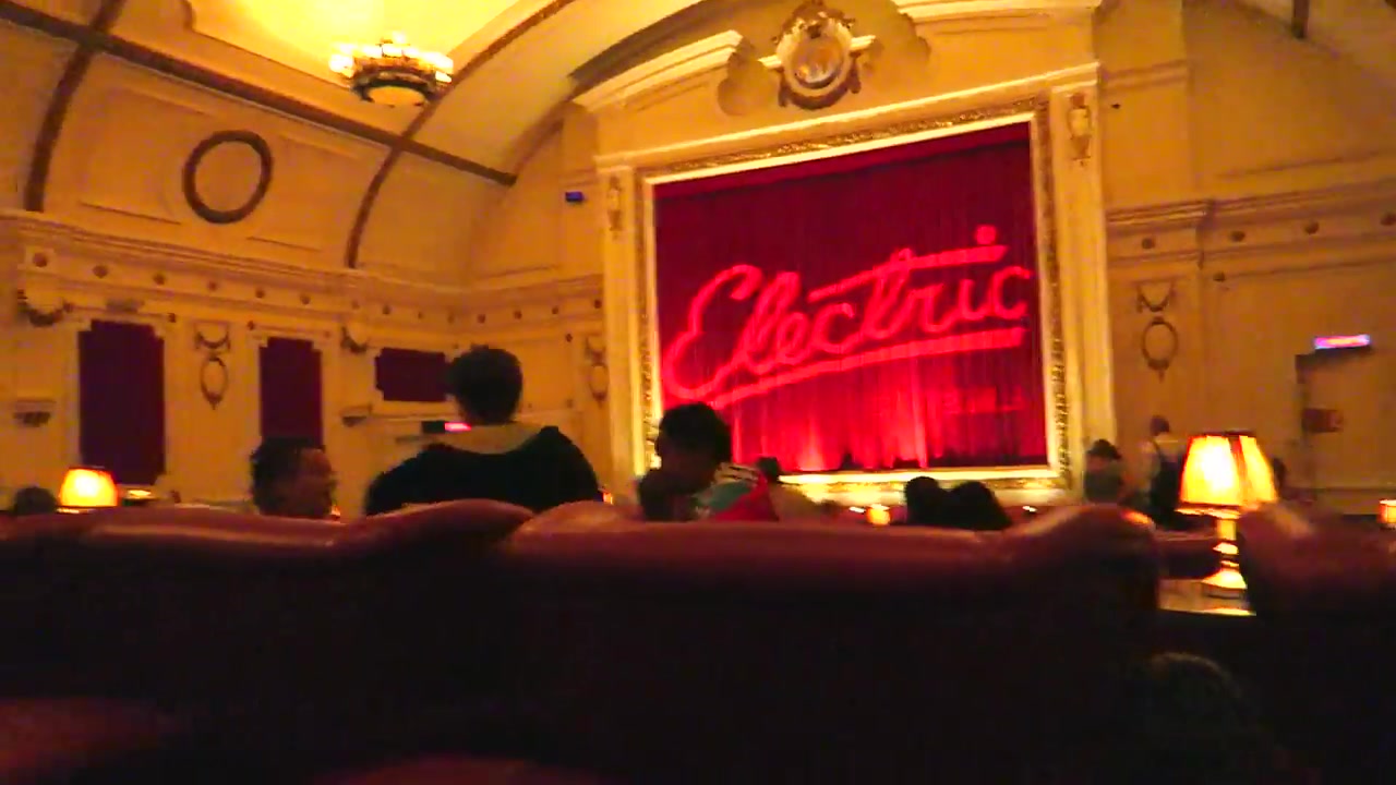 Red leather armchairs and illuminated screen inside the Electric Cinema