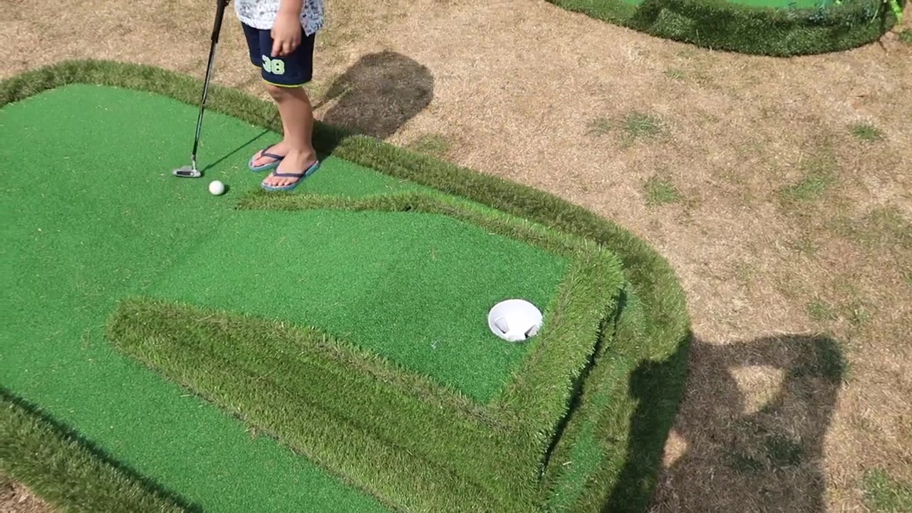 A child playing miniature golf at Lambeth Country Show in Brockwell Park