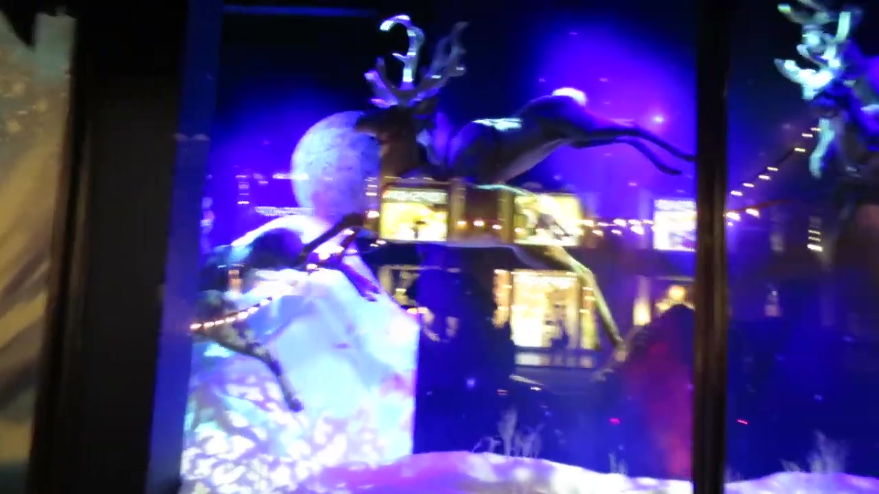 Father Christmas and flying reindeer in a blue Harrods window display