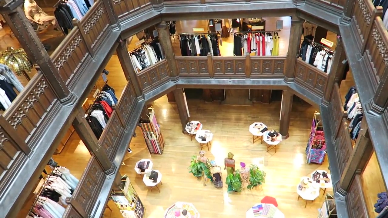 View down through the dark timber galleries of Liberty London's atrium