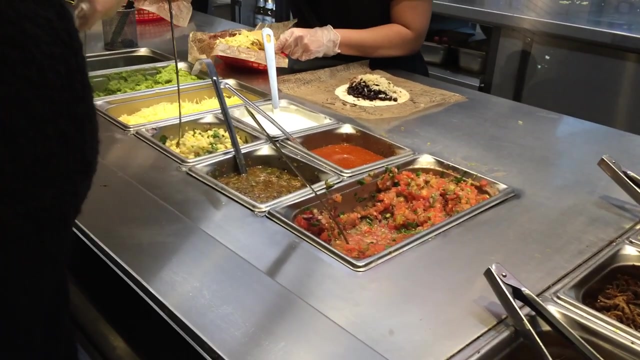 Fresh salsa and toppings at a Chipotle counter in London