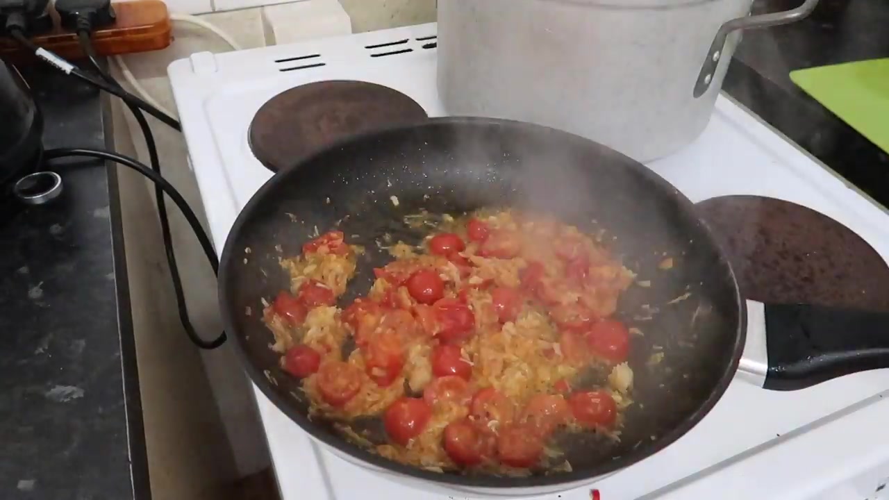 Tomato and seafood sauce cooking in a frying pan