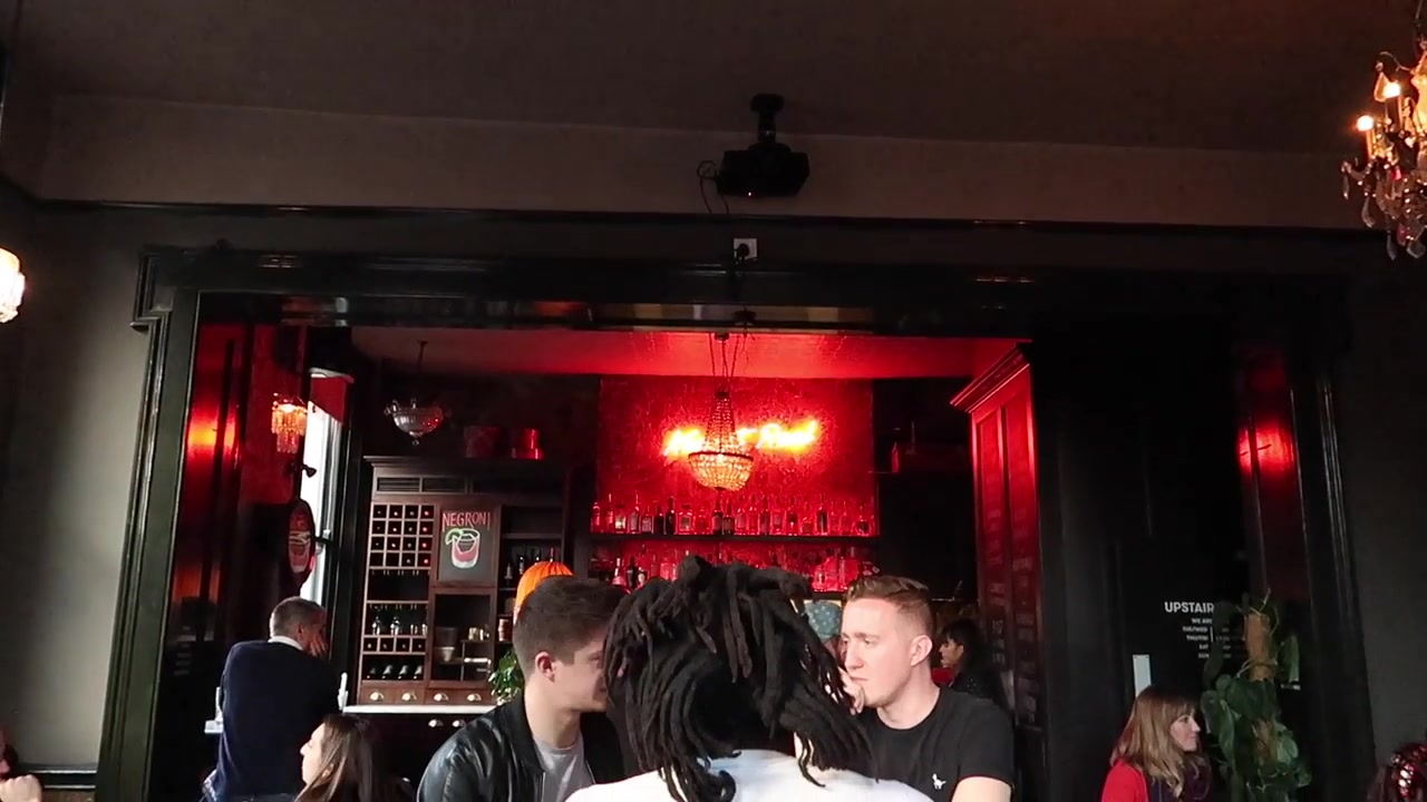 Customers in the warmly lit ground-floor bar of the Ten Bells