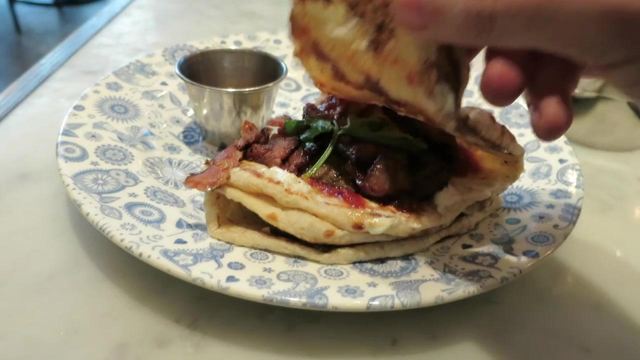 Smoked bacon, herbs and chilli tomato jam inside a Dishoom naan roll