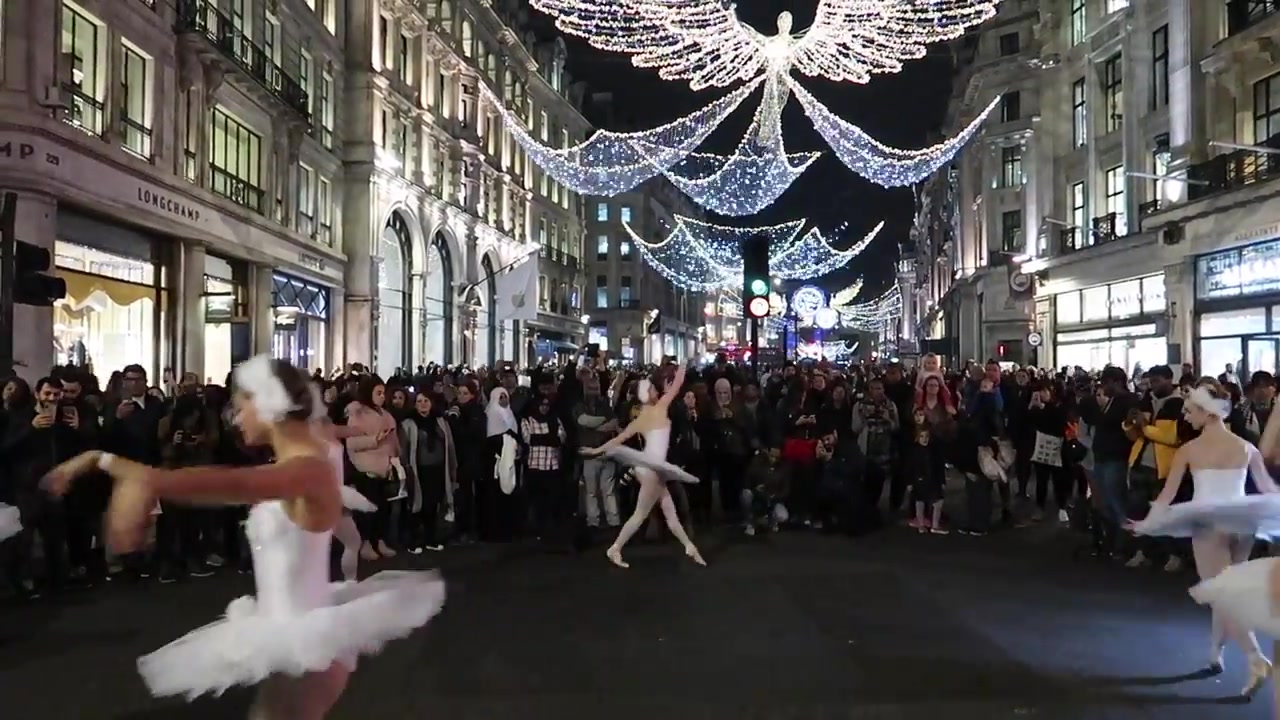 Ballet dancers performing beneath the Regent Street Christmas angels