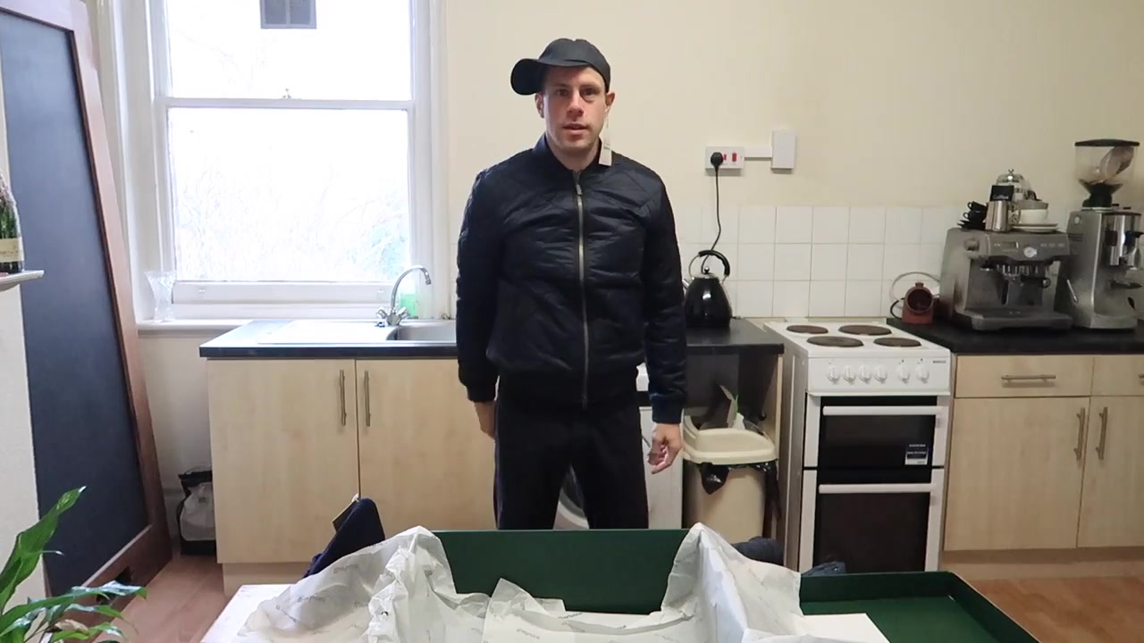 Barry Roberts testing a navy Barbour wax sports cap with a quilted jacket in front of the camera.