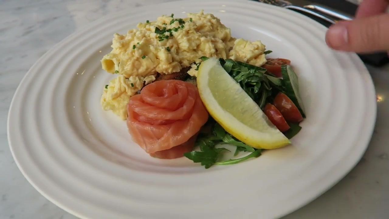 Scrambled eggs with smoked salmon, salad and lemon at Liberty London