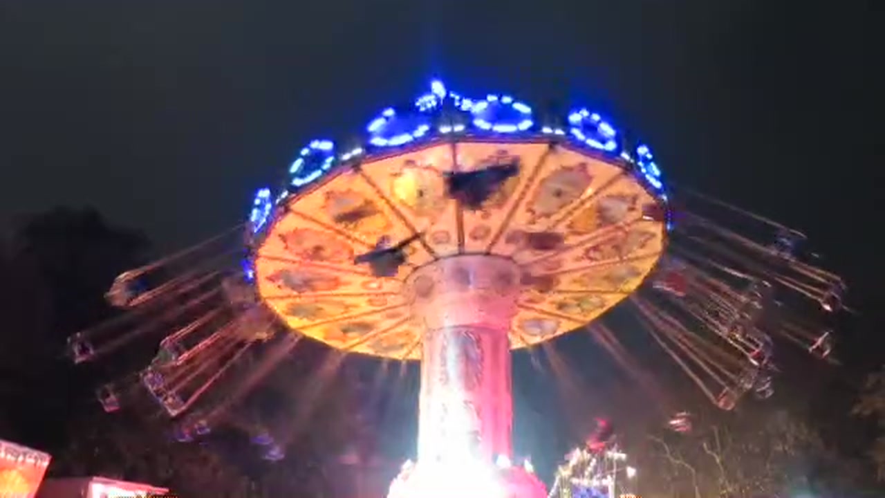 Illuminated chair-swing ride turning against the night sky at Winter Wonderland