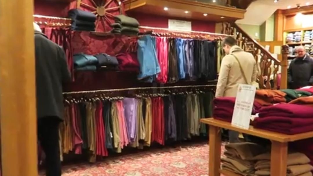 Colourful trousers and knitwear displayed inside Cordings of Piccadilly