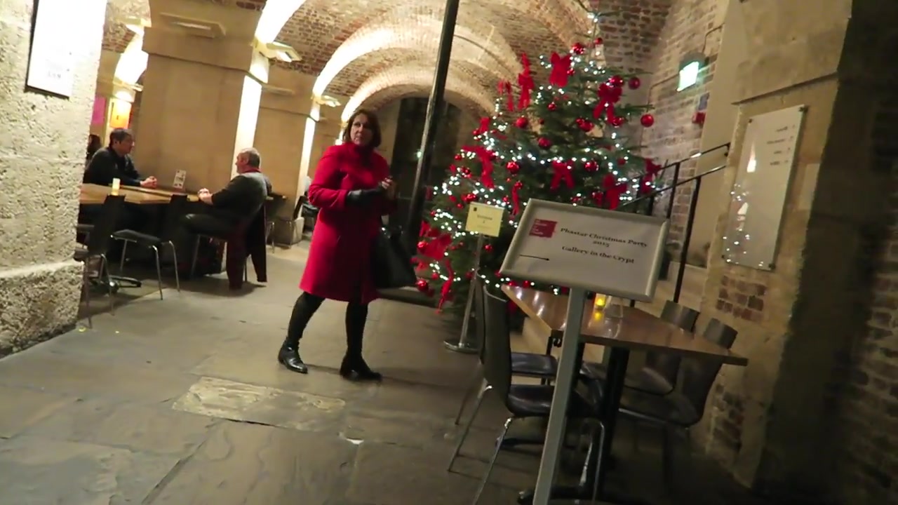 Christmas tree among the brick arches inside Café in the Crypt in London