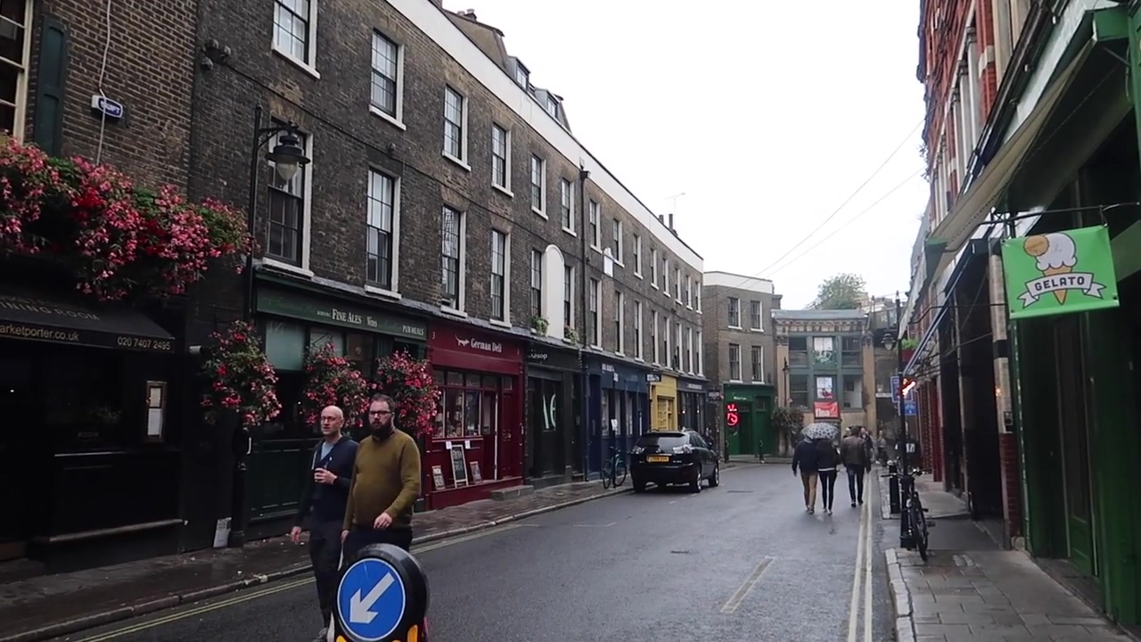 Rainy queue of customers outside Monmouth Coffee at Borough Market