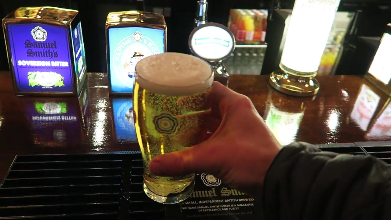 Samuel Smith pint held inside The Chandos pub in London