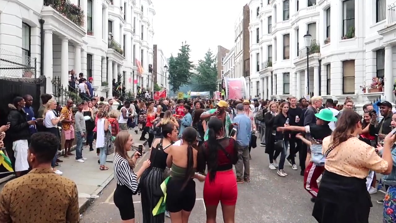 Crowds dancing and watching performers in a Notting Hill street during Carnival 2018