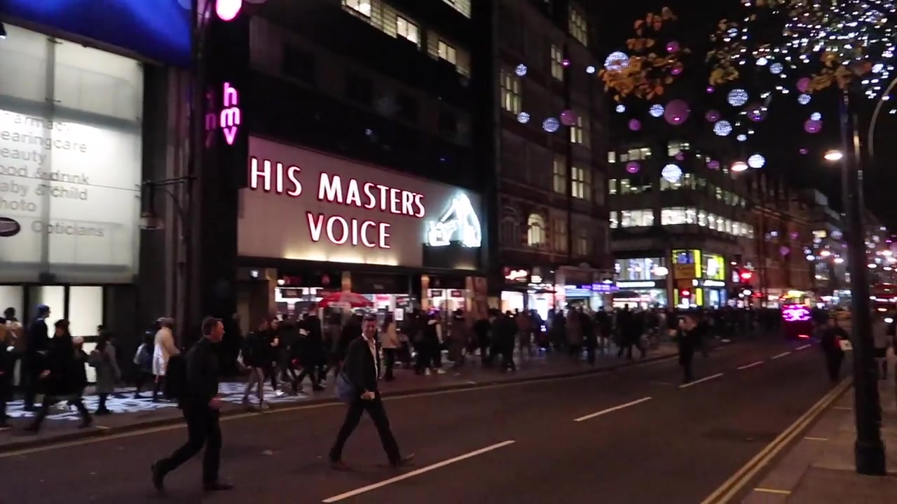 Boots and His Master’s Voice signs beneath Oxford Street Christmas lights in 2018