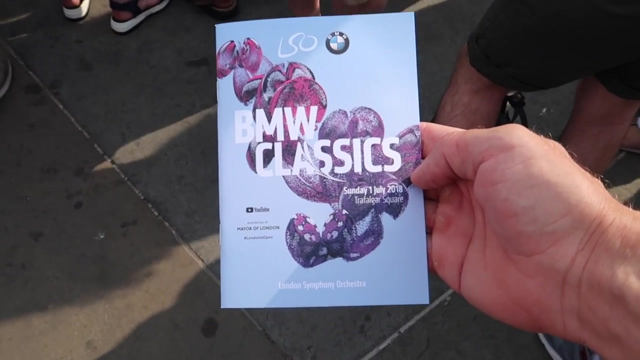 BMW Classics 2018 programme card held beside a Trafalgar Square lion