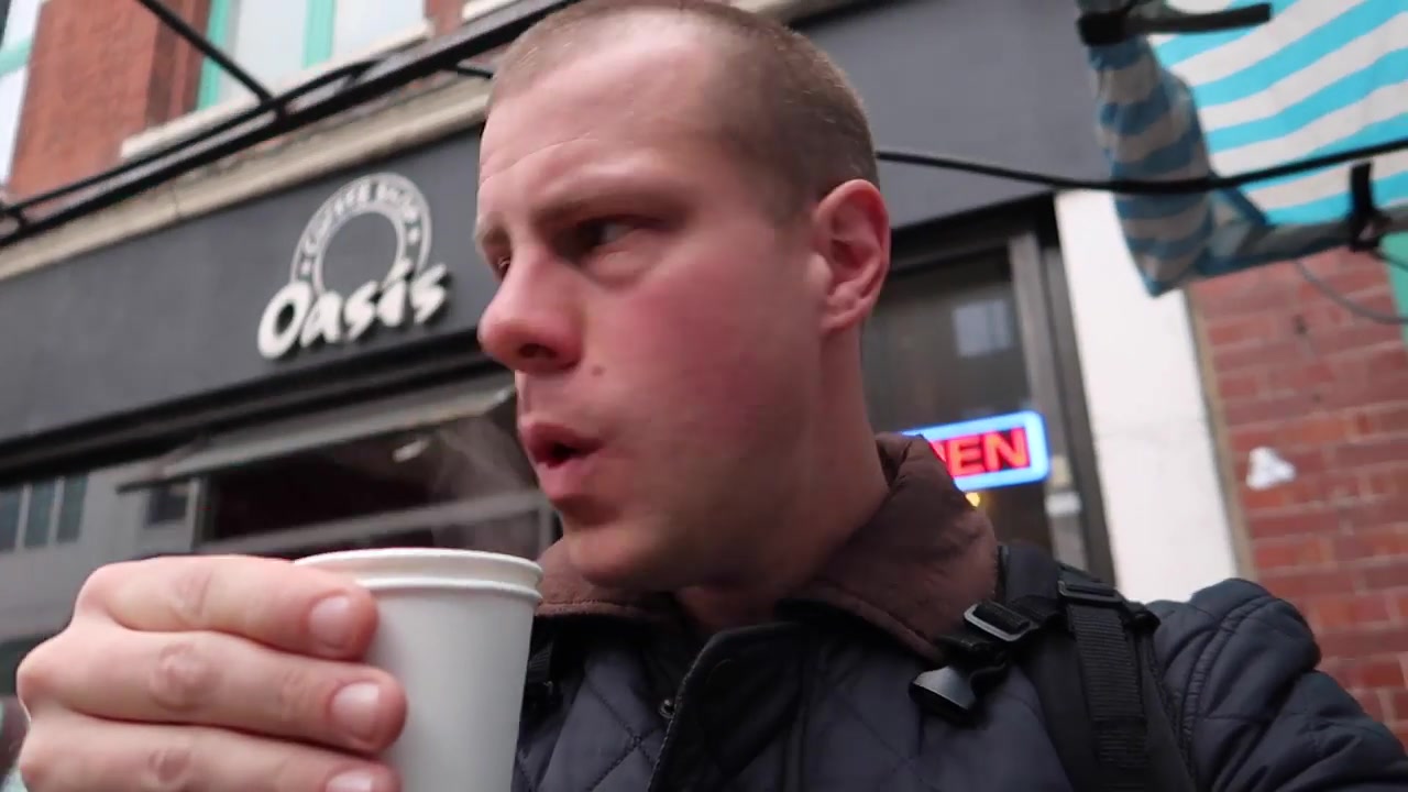 Barry Roberts drinking a long black coffee outside on Leather Lane Market