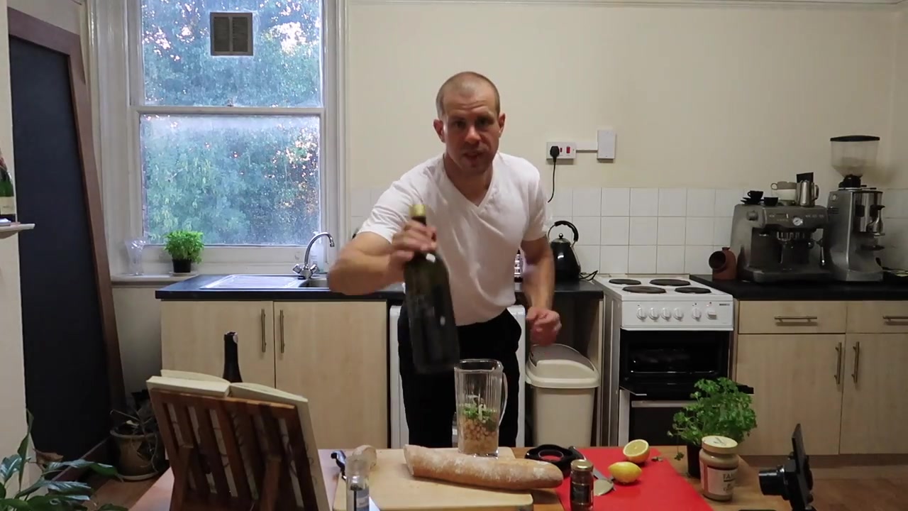 Barry Roberts spooning chickpea and anchovy topping onto toasted bread