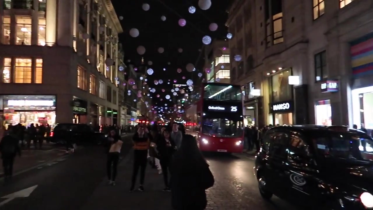 Evening crowds and traffic beneath Christmas lights near Oxford Circus in 2018