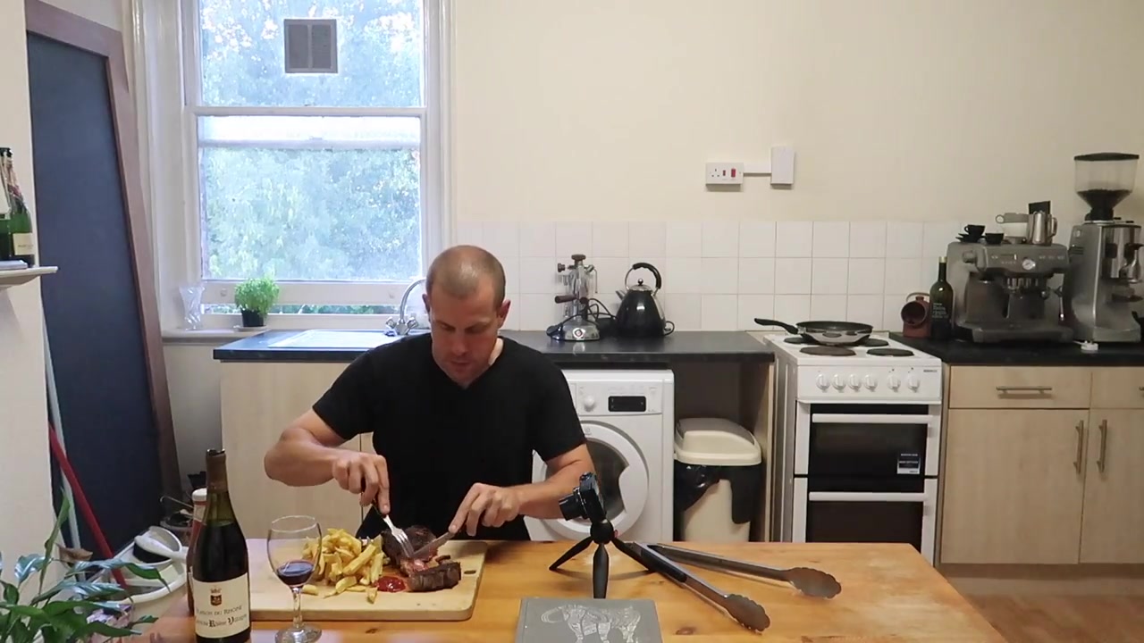Barry Roberts tasting the finished steak and chips in the London kitchen