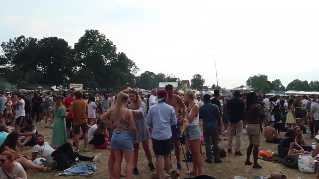 Green-costumed drummers performing among the crowd at Lambeth Country Show