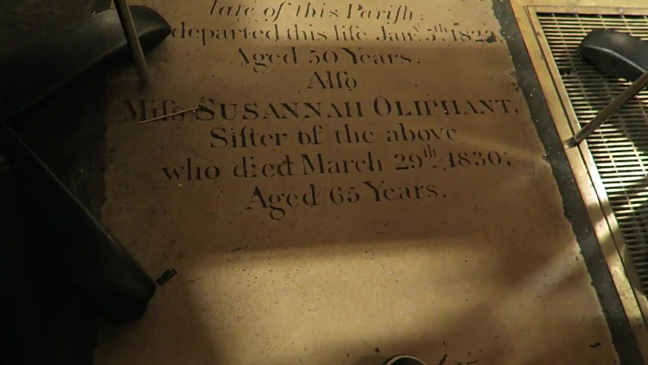 Historic memorial stone forming part of the floor inside Café in the Crypt
