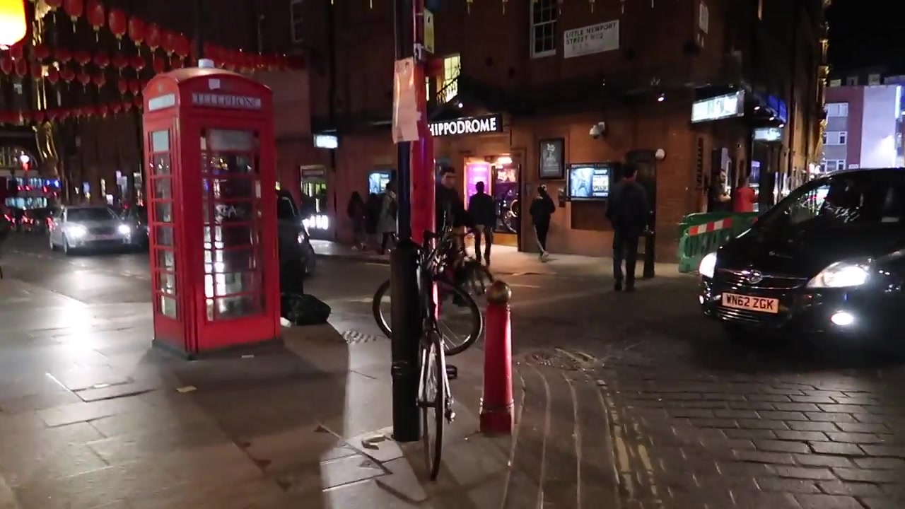 Quiet London Chinatown street with lanterns and shopfronts at the end of the evening