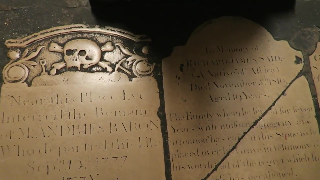 Historic memorial stone with a carved skull inside the crypt at St Martin-in-the-Fields