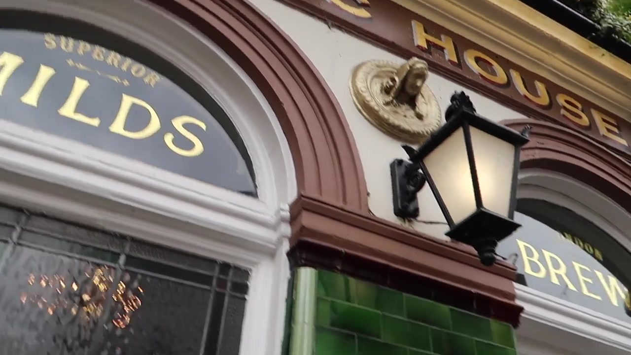 Decorative tiled pub frontage and lantern near Leather Lane Market