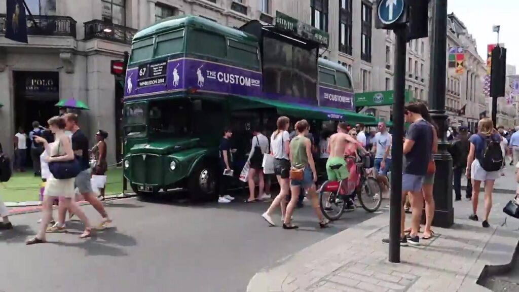 Vintage green double-decker bus and pedestrians at Regent Street Summer Streets 2018