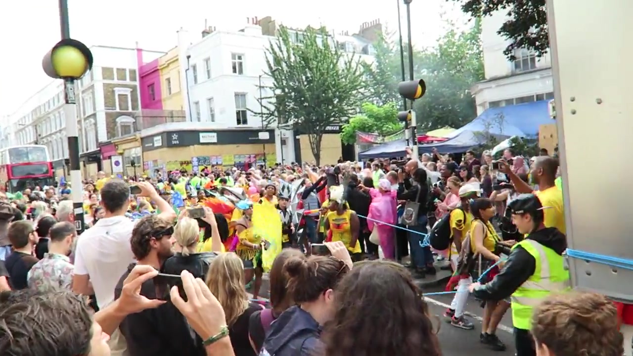 Crowds gathering beside the Notting Hill Carnival parade route