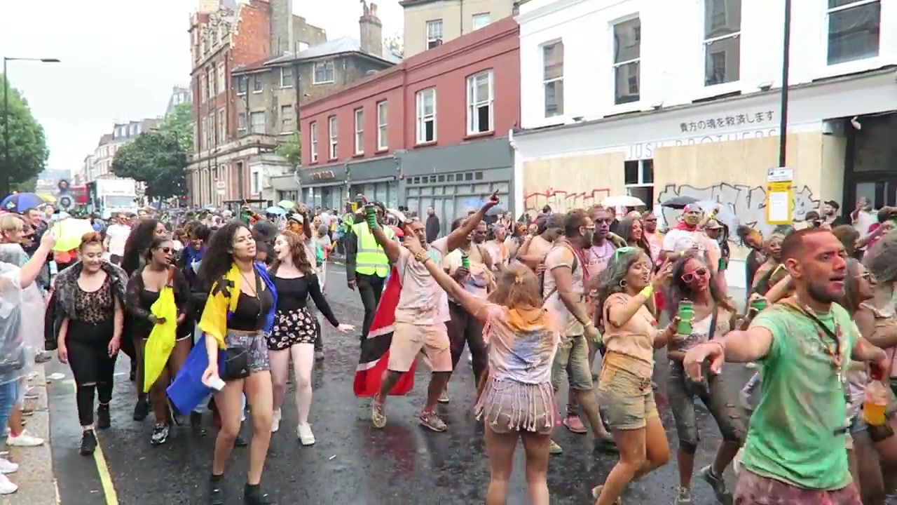 Dancers progressing along a west London street during Notting Hill Carnival