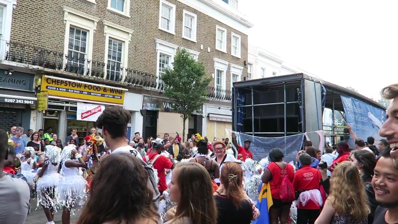 Carnival crowd beside a large mobile sound-system truck in Notting Hill