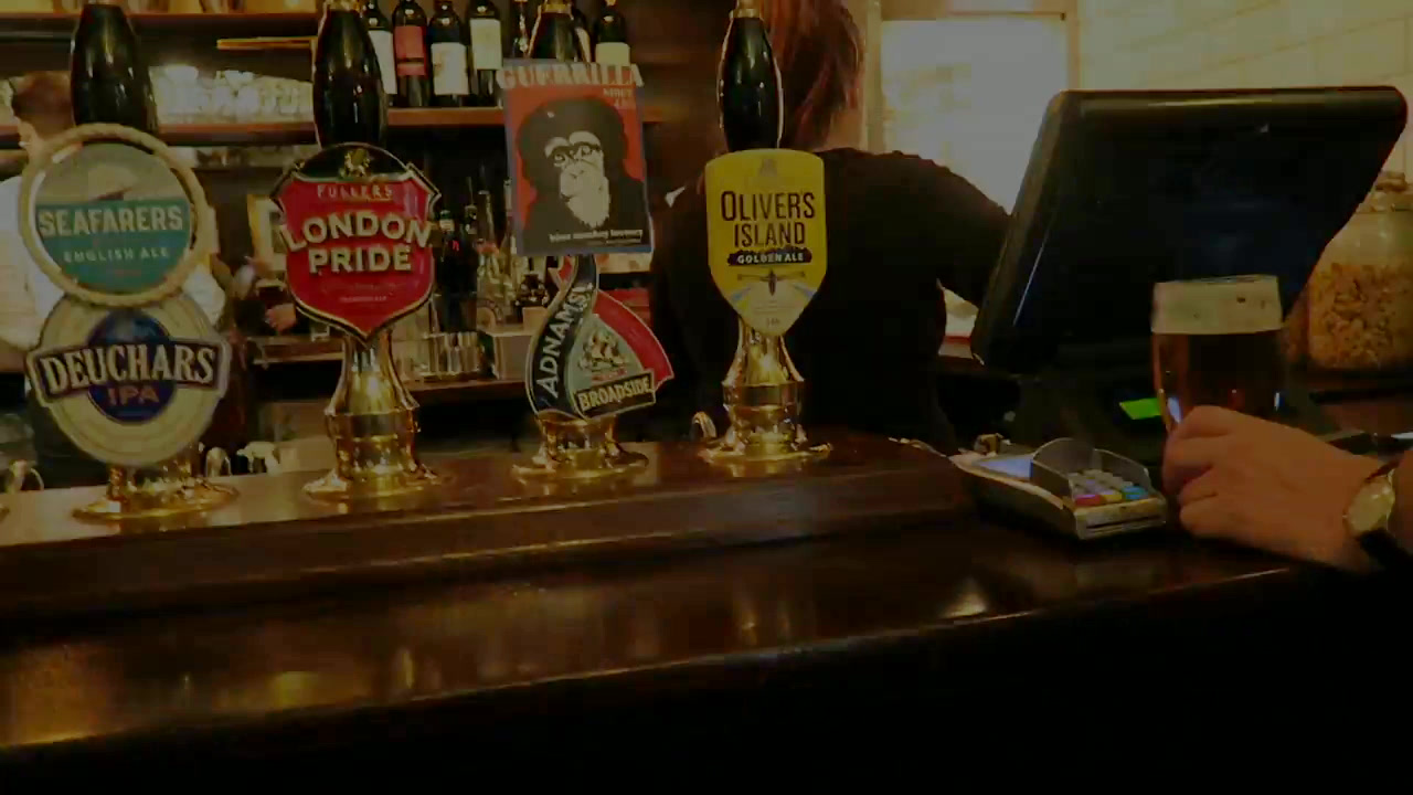 Real ale hand pumps on the front bar at Ye Olde Mitre in 2017