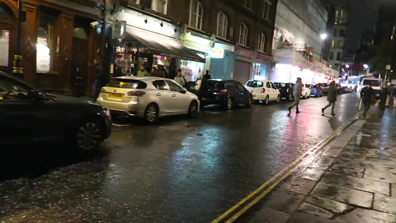 Broadwick Street in Soho at night with wet pavements and Christmas traffic in December 2016