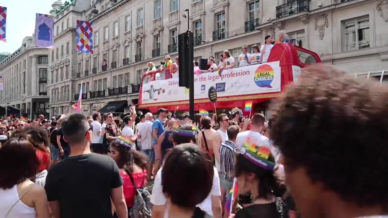 Talking Pride in the Legal Profession bus moving through the Pride in London crowd