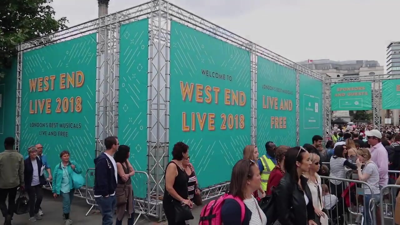 Visitors entering West End LIVE in Trafalgar Square beneath turquoise event signs
