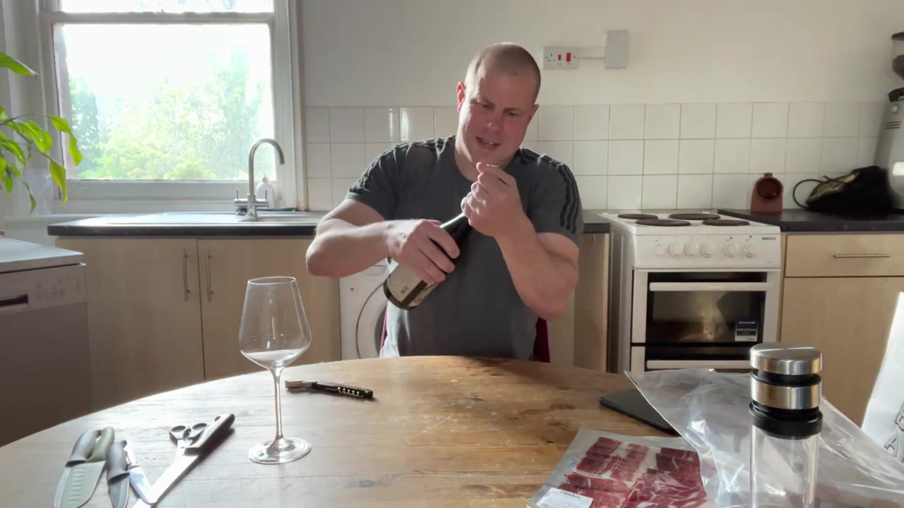 Bottle of red wine from Bedales beside a tasting glass in 2022