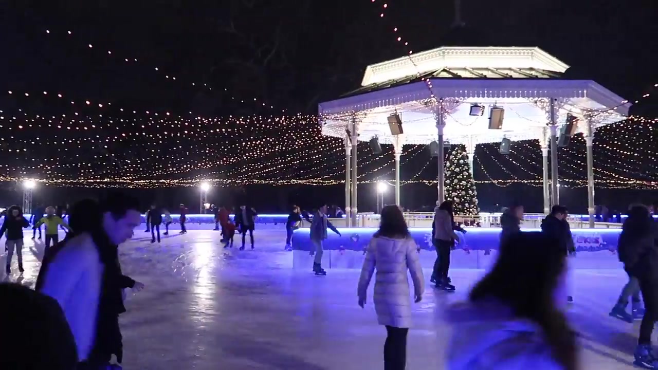 Skaters beneath festive lights in the opening Christmas montage.