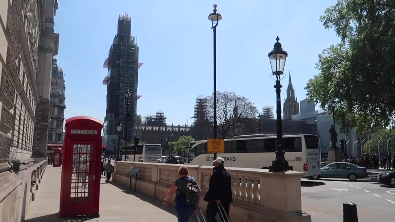 Elizabeth Tower under restoration beside a red telephone box in 2018