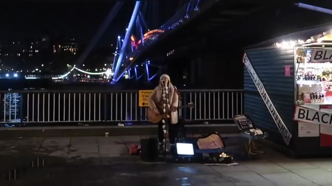 Street performer on Golden Jubilee Bridge in London