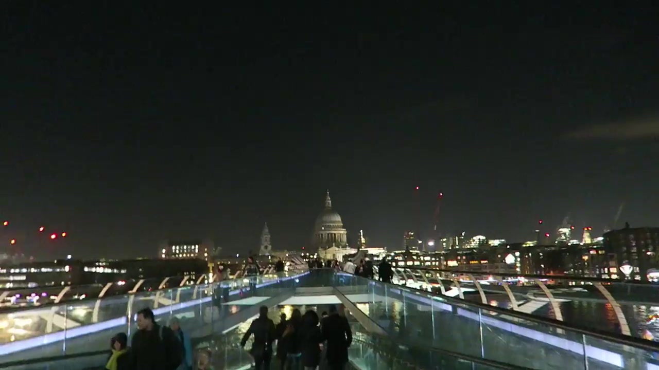 Illuminated Millennium Bridge leading towards St Paul’s Cathedral on a winter night in London