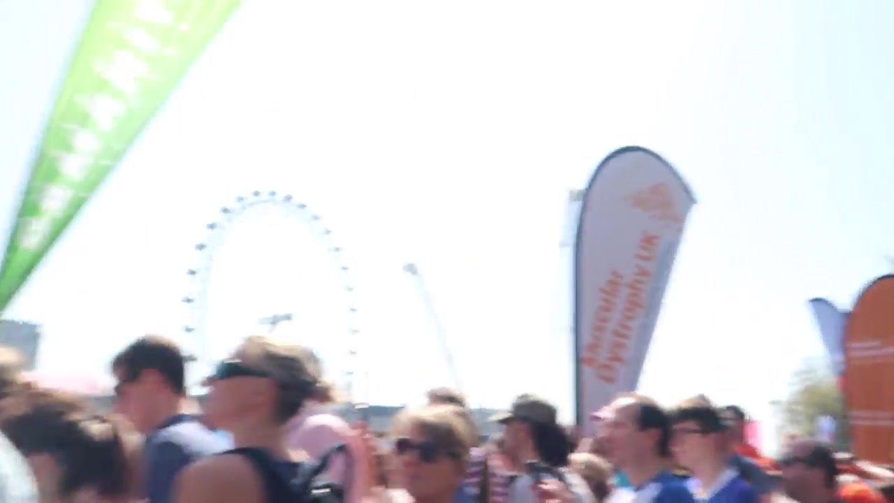 London Marathon runners passing spectators near the London Eye in 2018